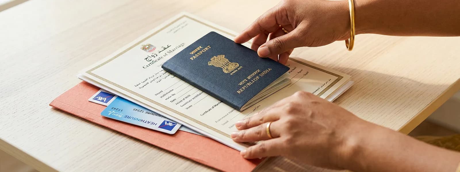 Neatly arranged document stack on desk with passport, marriage certificate with Arabic text, and insurance card